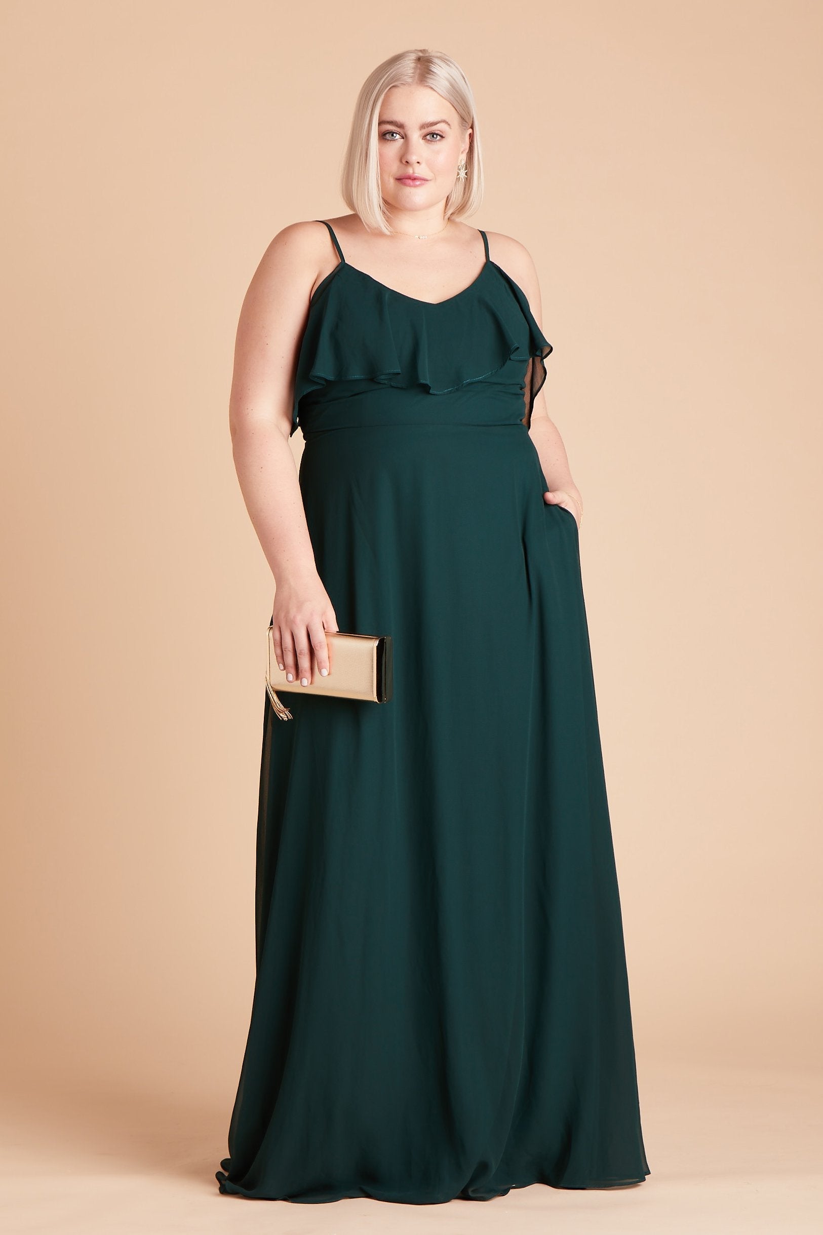 Jane convertible plus size bridesmaid dress in emerald green chiffon by Birdy Grey, front view with hand in pocket