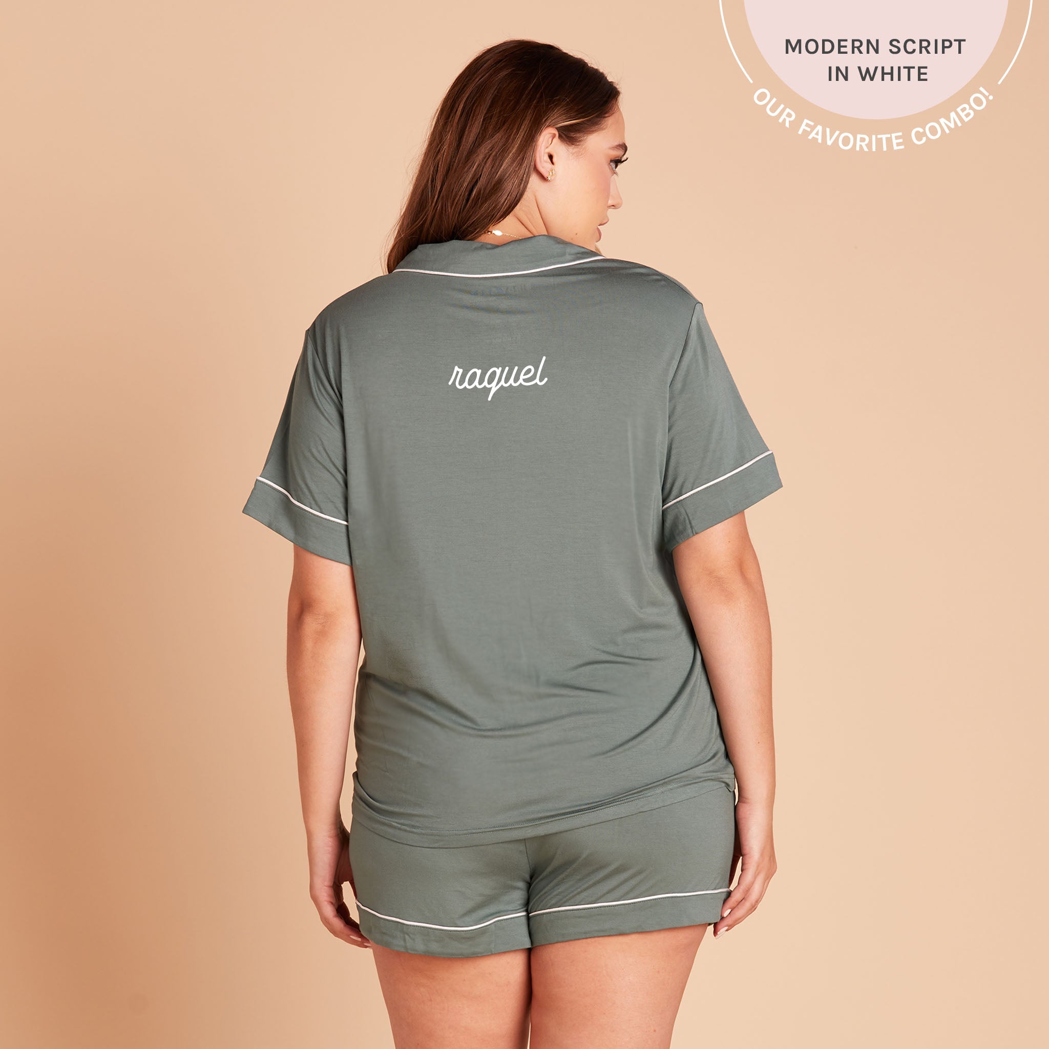 Back view of the Jonny Plus Size Pajama Set in sea glass demonstrates the optional name personalization embroidered in the center of the pajama top, between the shoulder blades. The embroidery reads, “Raquel,” in white, with a callout at the top of the photo that reads, “Bold serif in white. Our favorite combo!”