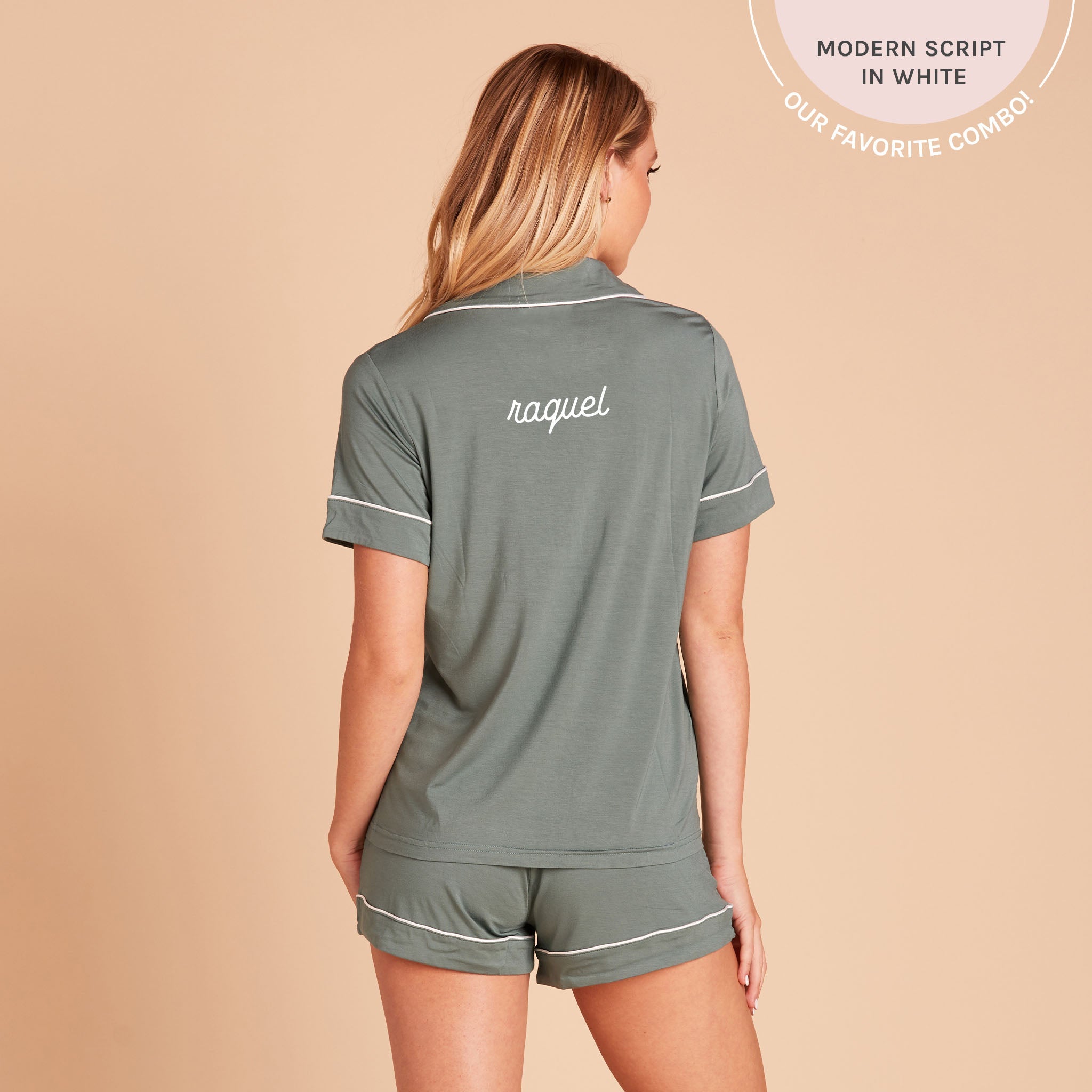 Back view of the Jonny Pajama Set in sea glass demonstrates the optional name personalization embroidered in the center of the pajama top, between the shoulder blades. The embroidery reads, “Raquel,” in white, with a callout at the top of the photo that reads, “Bold serif in white. Our favorite combo!”