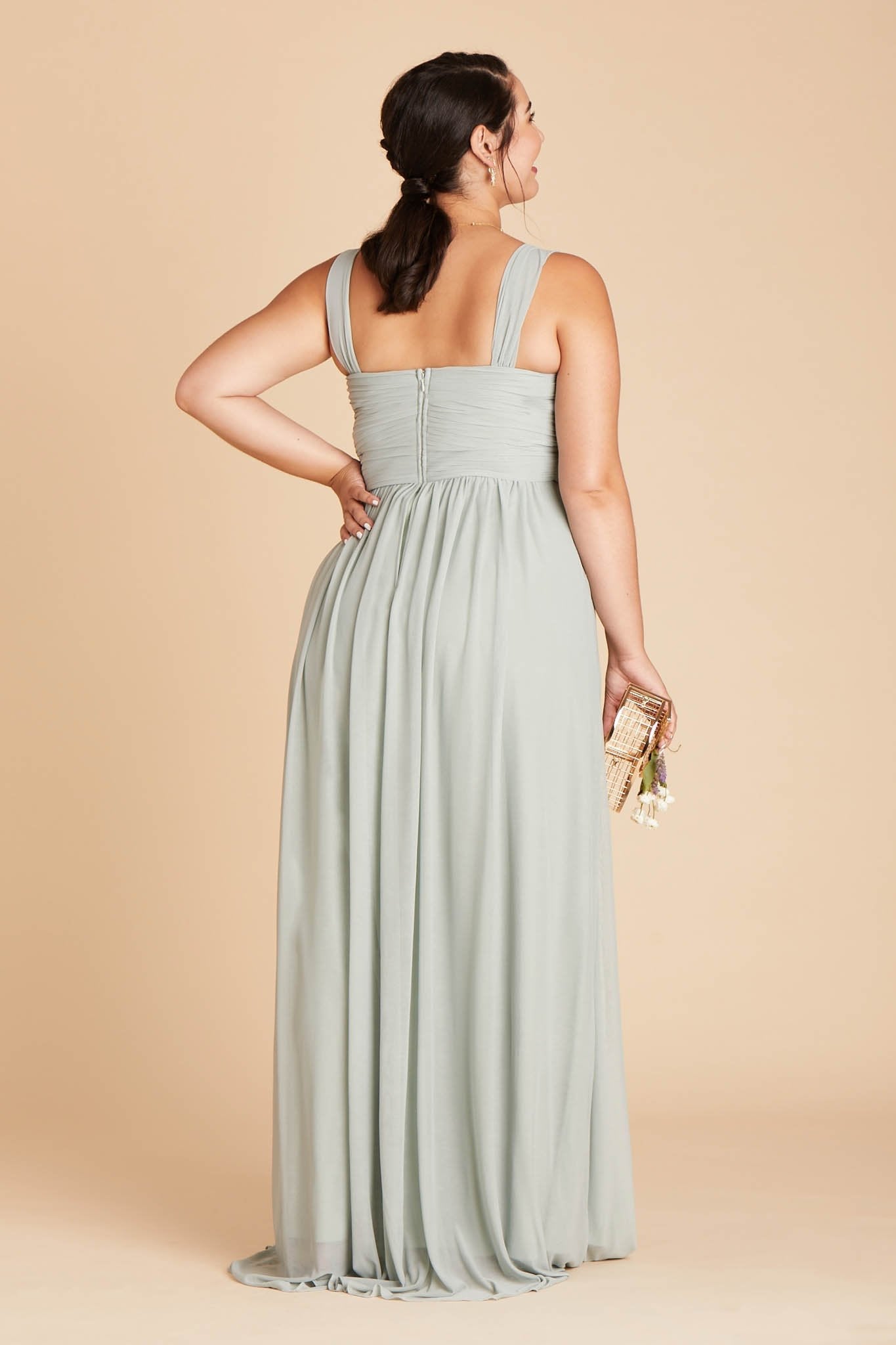 Back view of the Elsye Plus Size Bridesmaid Dress in dusty rose mesh reveals a square cut just below the shoulder blades and the pleated column skirt gracefully flowing to the floor.