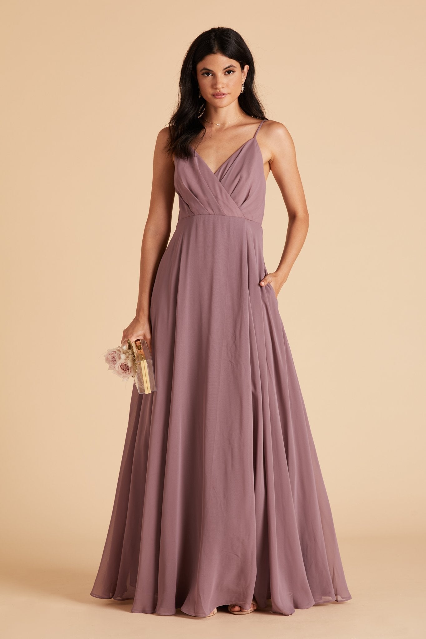 Kaia bridesmaids dress in dark mauve purple chiffon by Birdy Grey, front view with hand in pocket