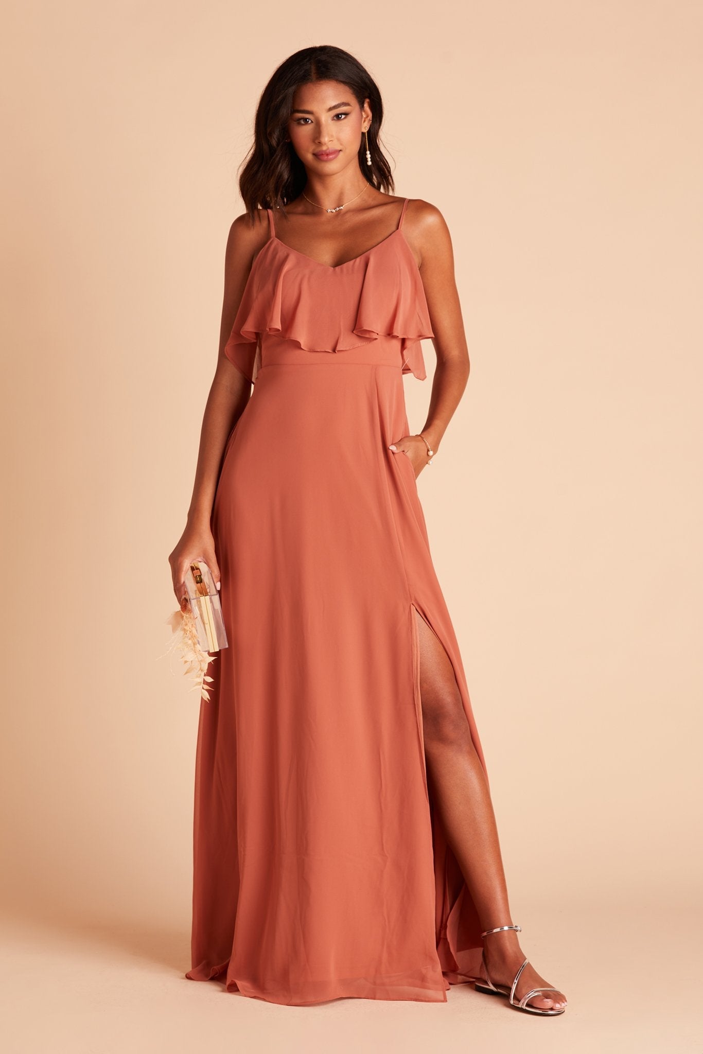 Jane convertible bridesmaid dress with slit in terracotta orange chiffon by Birdy Grey, front view with hand in pocket