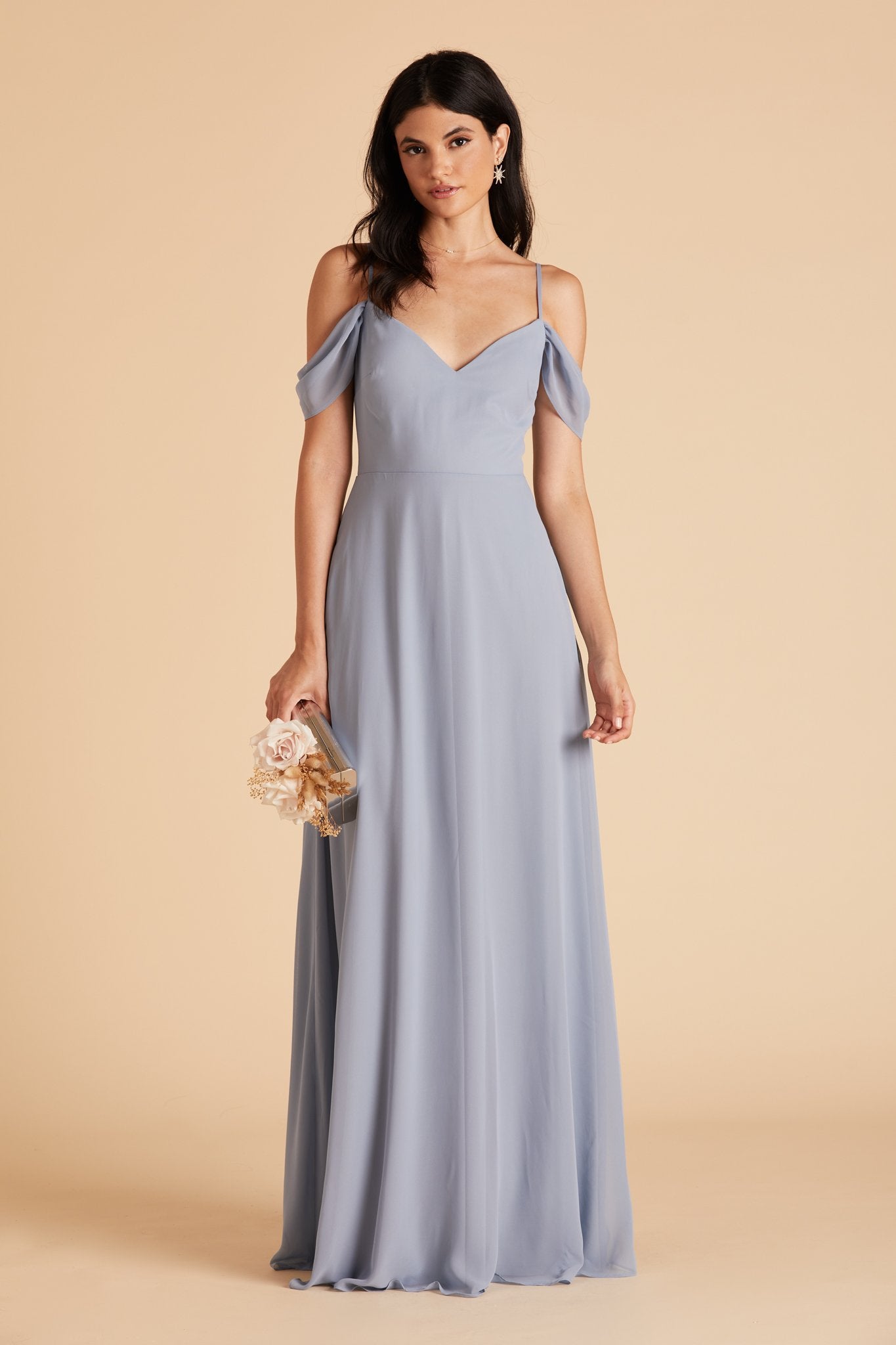 Front view of the floor-length Devin Convertible Bridesmaid Dress in dusty blue chiffon by Birdy Grey with a V-neck front. The flowing skirt has no slit, as this is an optional feature.