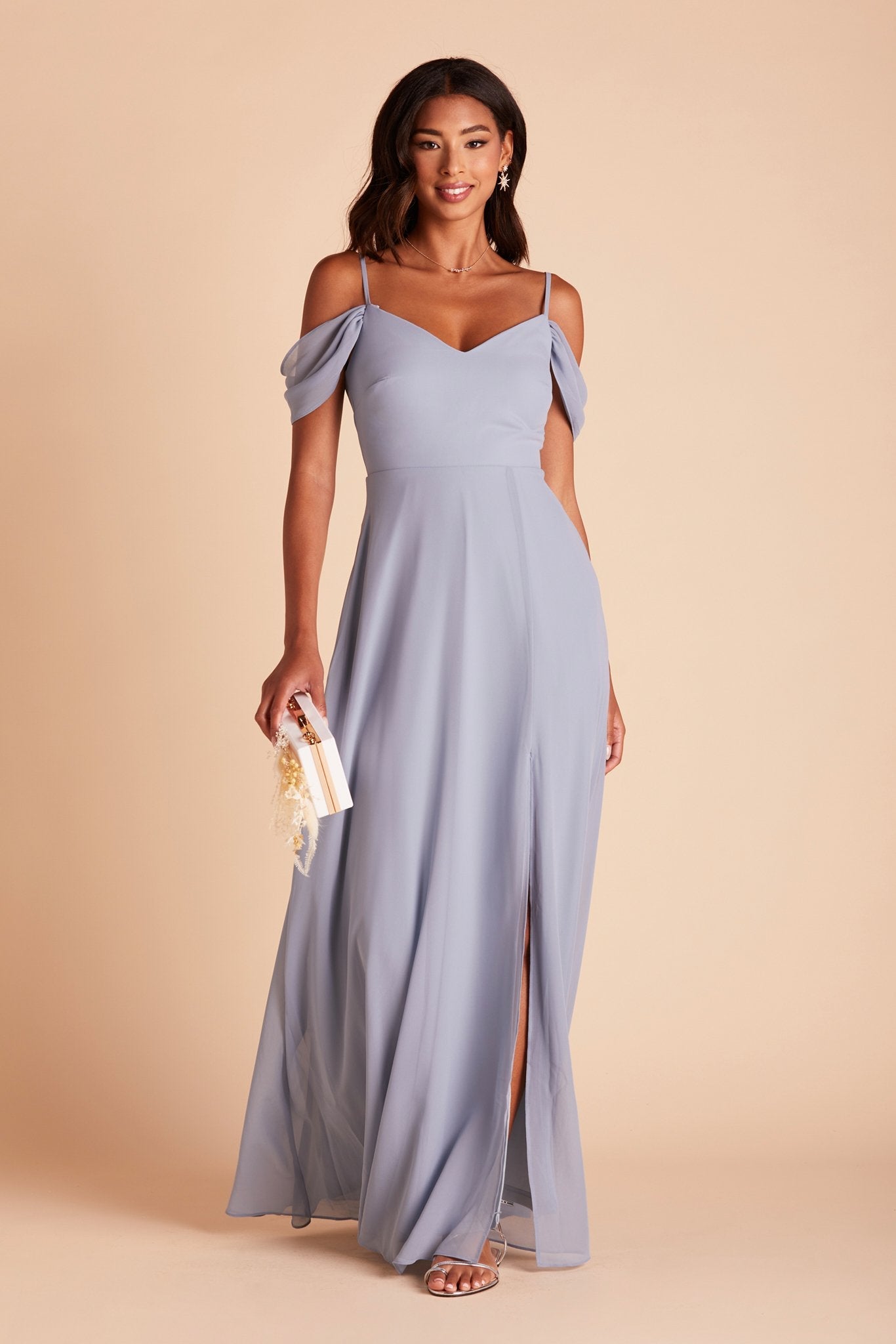 Front view of the floor-length Devin Convertible Bridesmaid Dress features a fitted bust and waist with a flowing skirt that moves with the model as she steps forward.