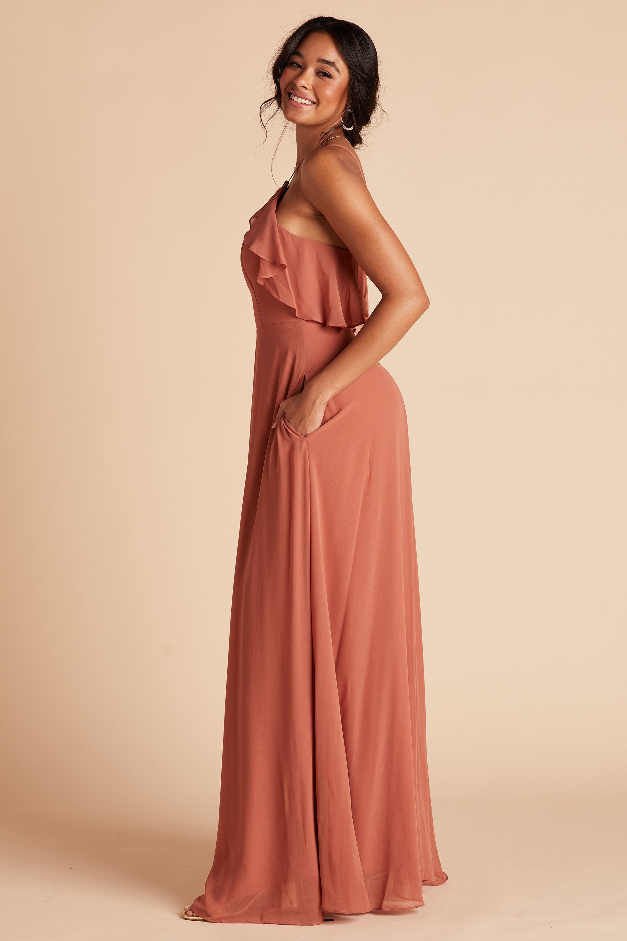 Jules bridesmaid dress in terracotta orange chiffon by Birdy Grey, side view with hand in pocket