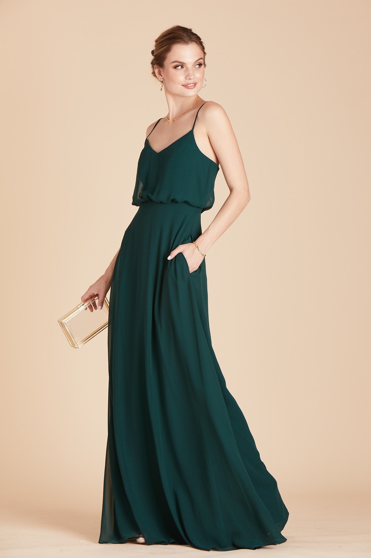 Gwennie bridesmaid dress in emerald green chiffon by Birdy Grey, front view with hand in pocket