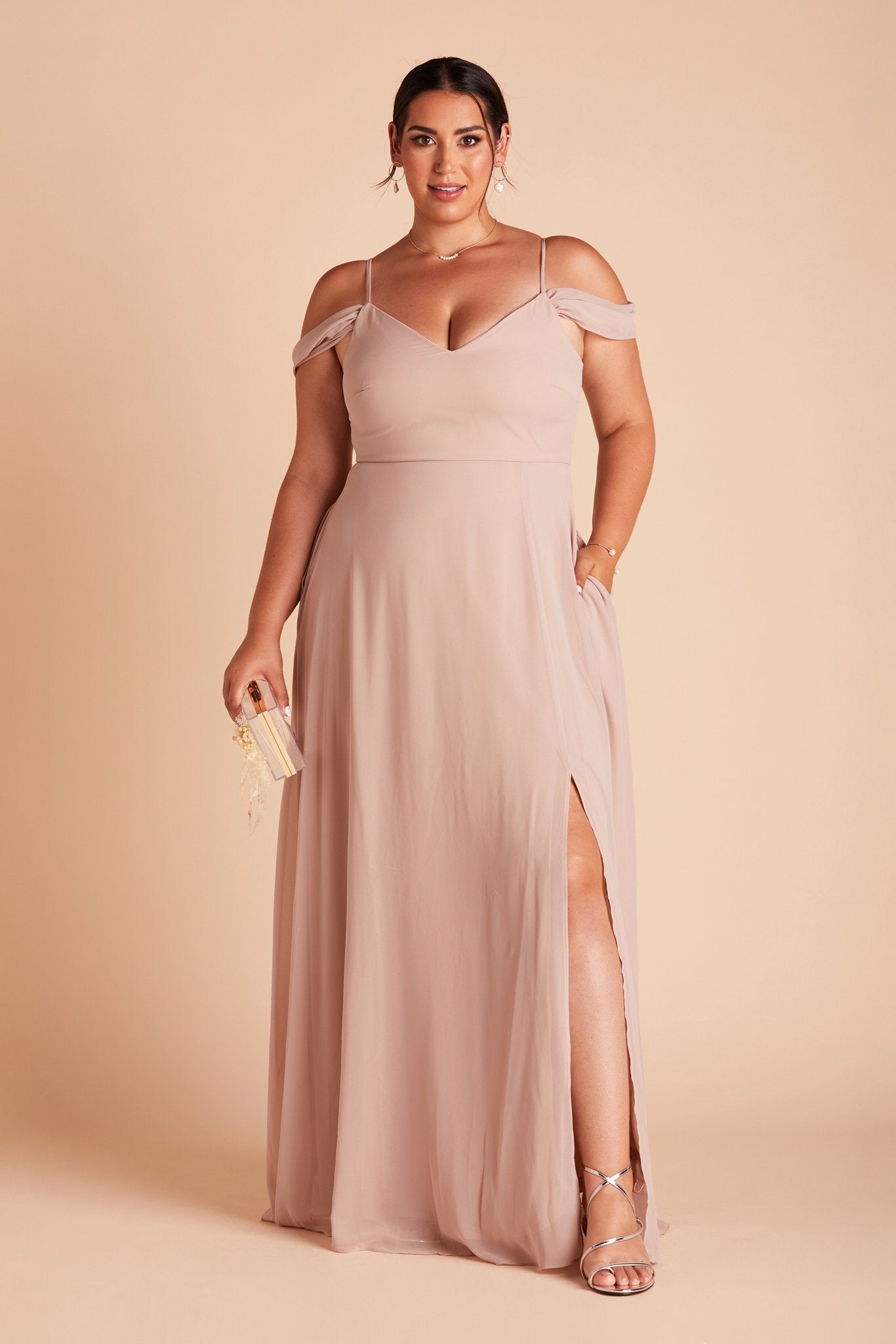 Devin convertible plus size bridesmaids dress with slit in taupe chiffon by Birdy Grey, front view with hand in pocket