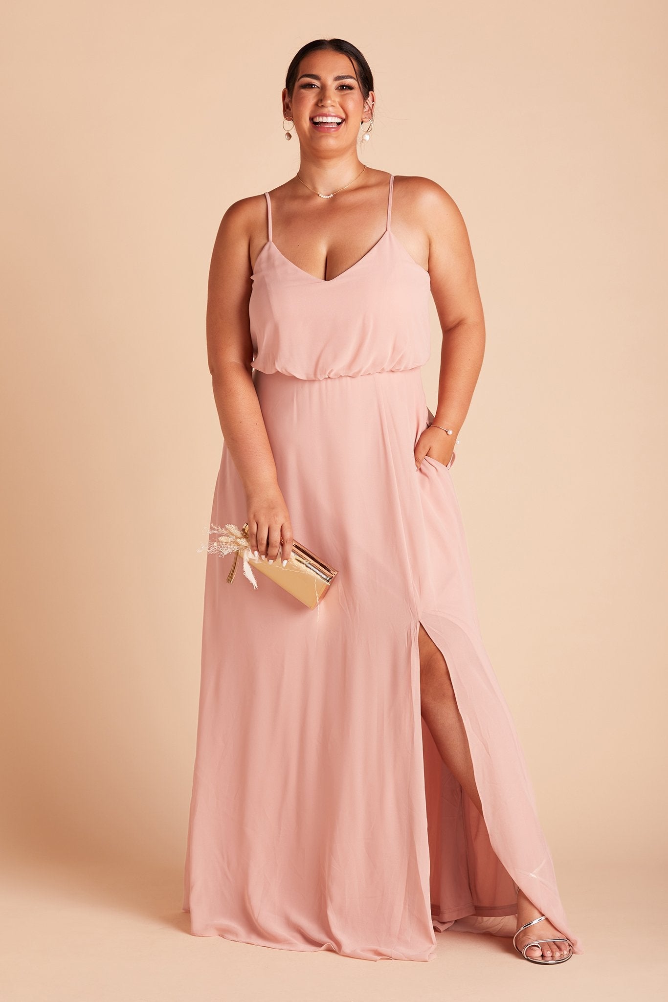 Gwennie plus size bridesmaid dress with slit in dusty rose chiffon by Birdy Grey, front view with hand in pocket 