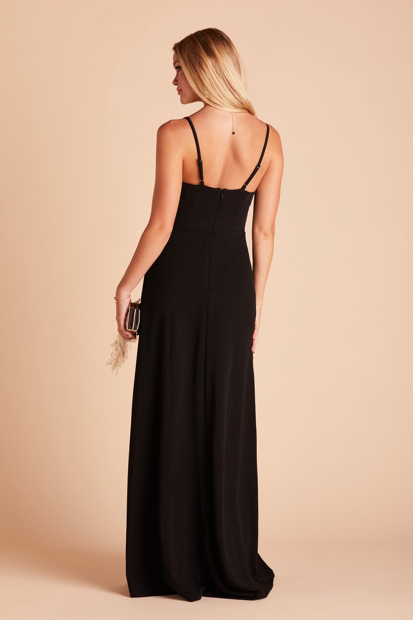 Back view of the Ash Bridesmaid Dress in black crepe shows skinny adjustable straps as well as an open back just below shoulder blades.