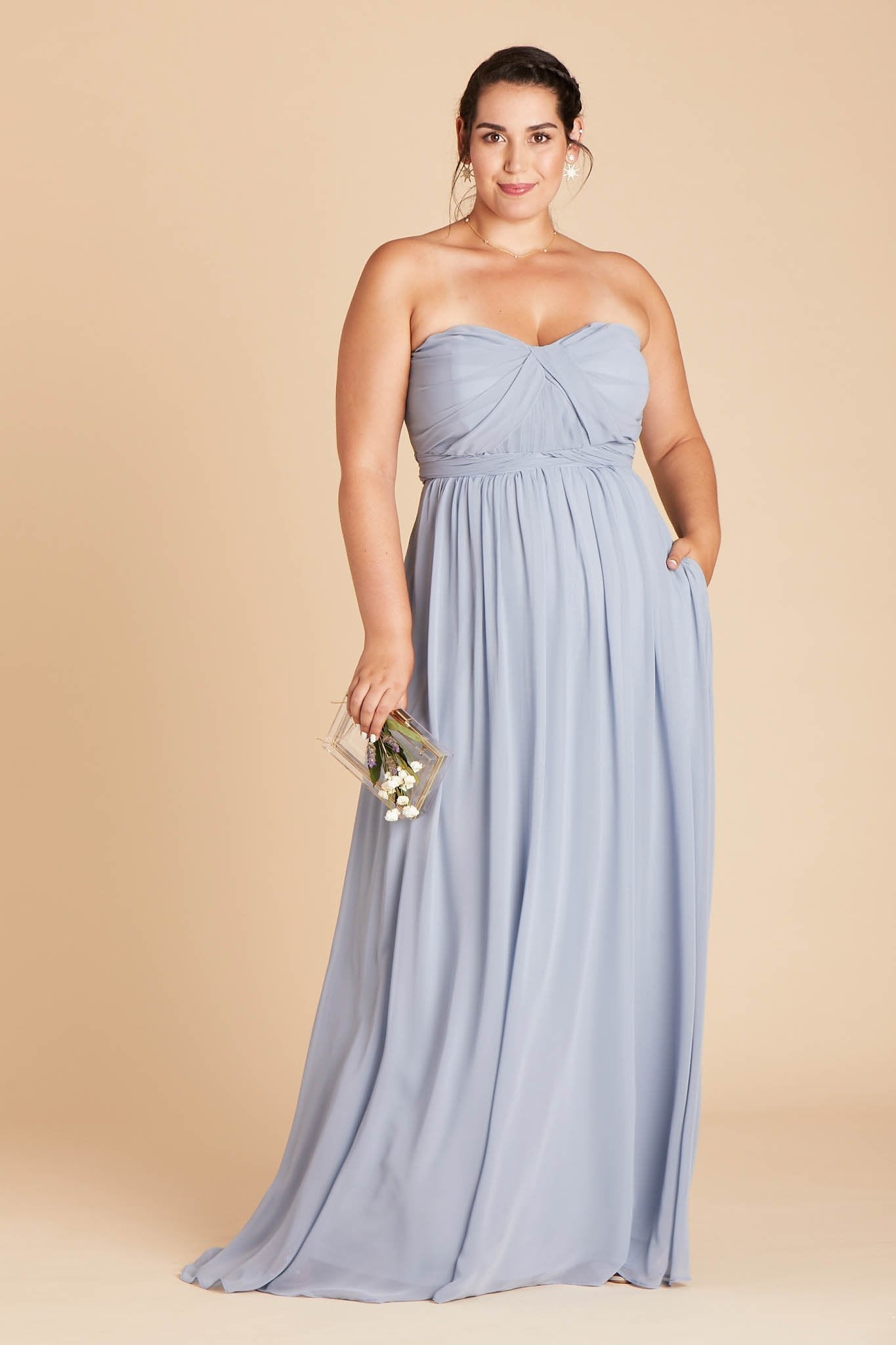 Grace convertible plus size bridesmaid dress in dusty blue chiffon by Birdy Grey, front view with hand in pocket