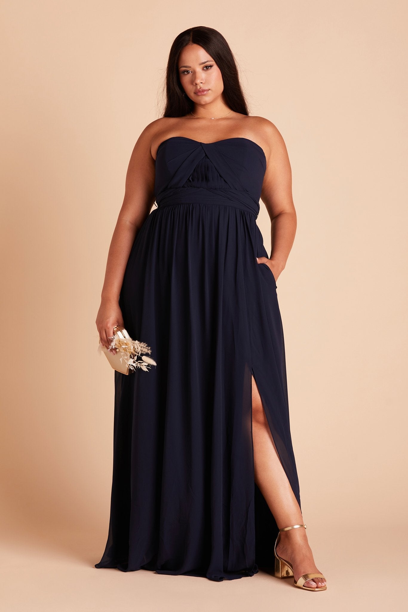 Grace convertible plus size bridesmaid dress in navy blue chiffon by Birdy Grey, front view with hand in pocket