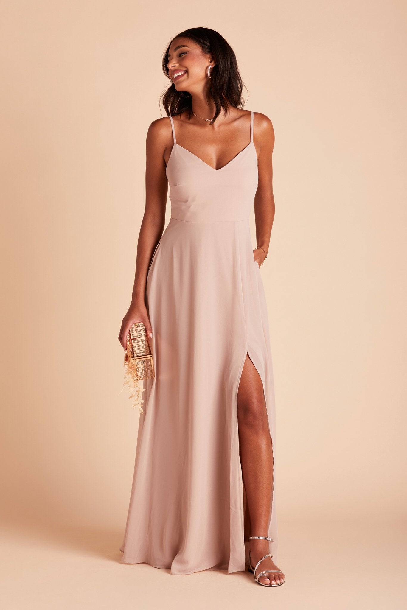 Devin convertible bridesmaids dress with slit in taupe chiffon by Birdy Grey, front view with hand in pocket