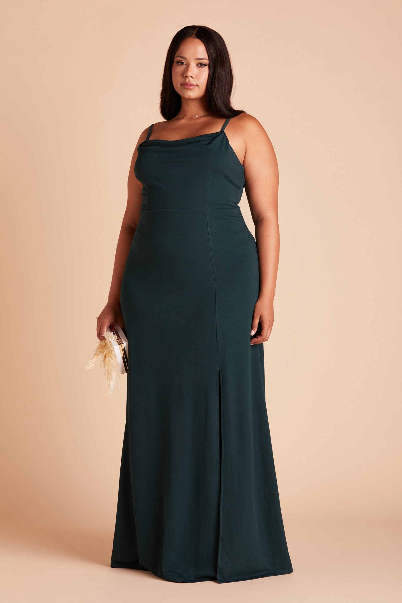 Front view of the floor-length Ash Plus Size Bridesmaid Dress in emerald crepe worn by a curvy model with medium-tone skin.