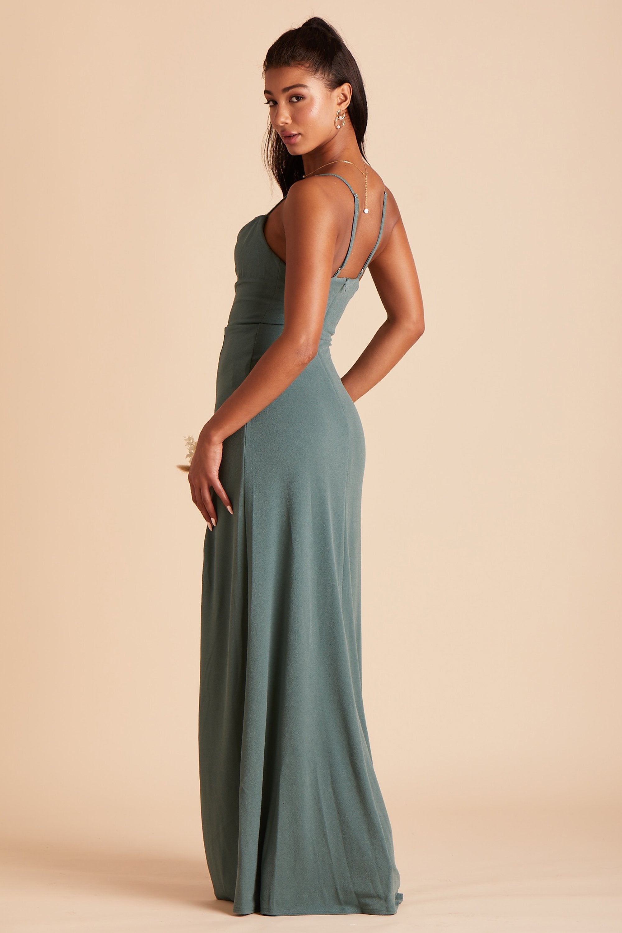 Side view of the Ash Bridesmaid Dress in sea glass crepe shows a slender silhouette with a fitted bust and waist and flowing skirt.