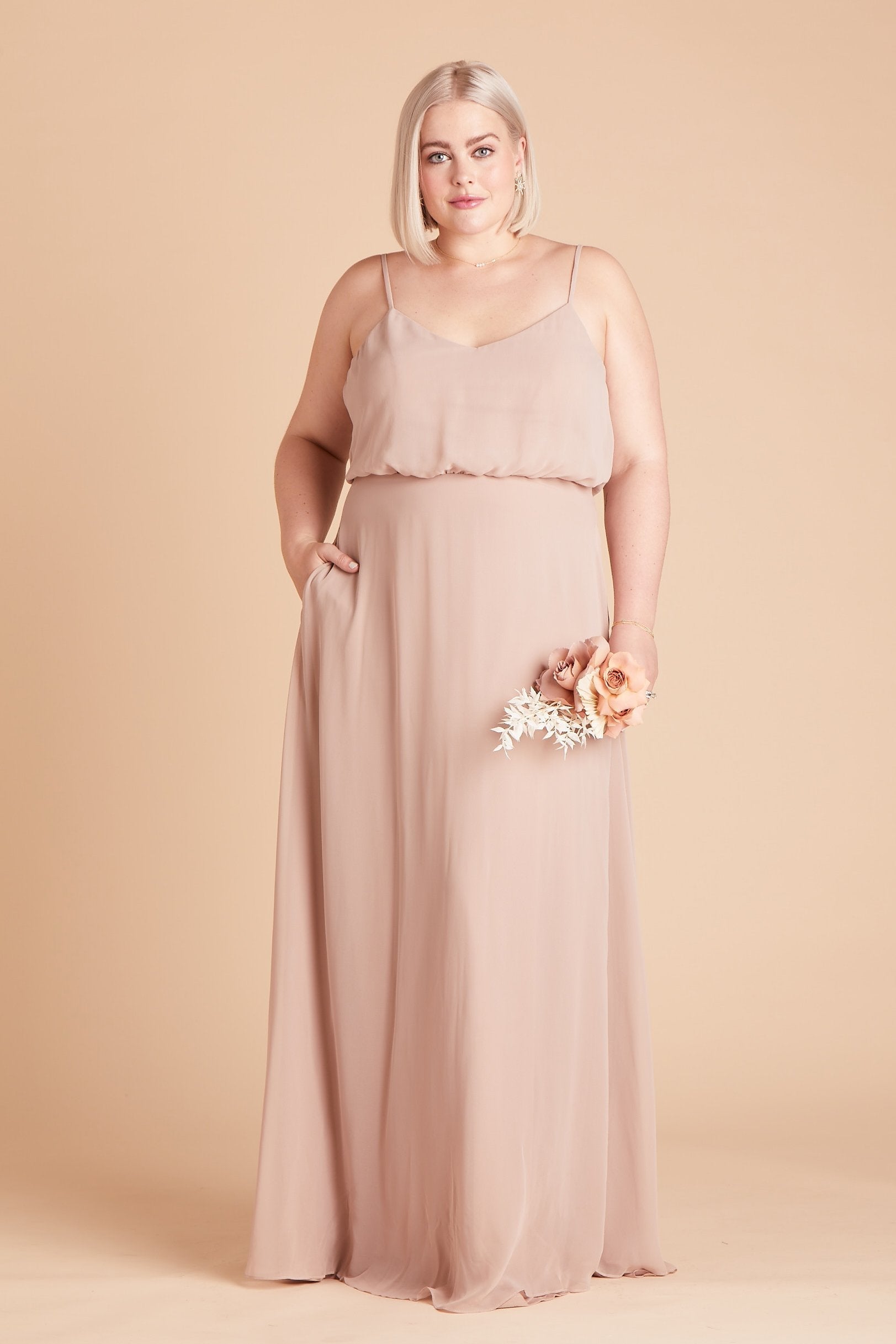 Gwennie plus size bridesmaid dress in taupe chiffon by Birdy Grey, front view with hand in pocket