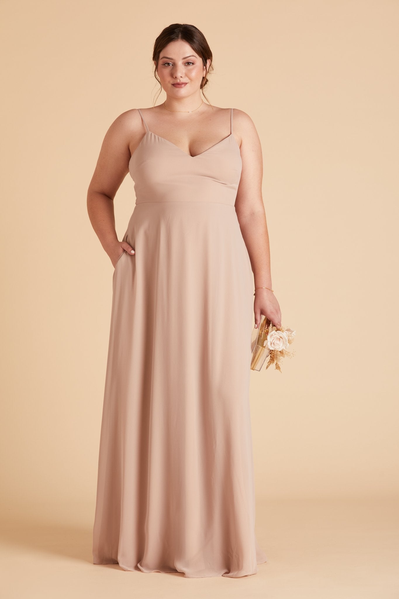 Devin convertible plus size bridesmaids dress in taupe chiffon by Birdy Grey, front view with hand in pocket