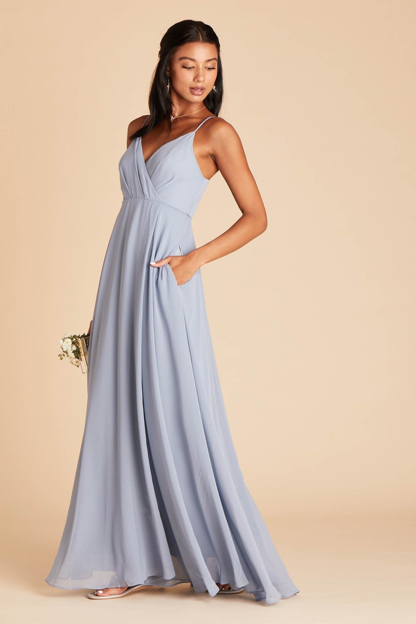 Kaia bridesmaids dress in dusty blue chiffon by Birdy Grey, side view with hand in pocket