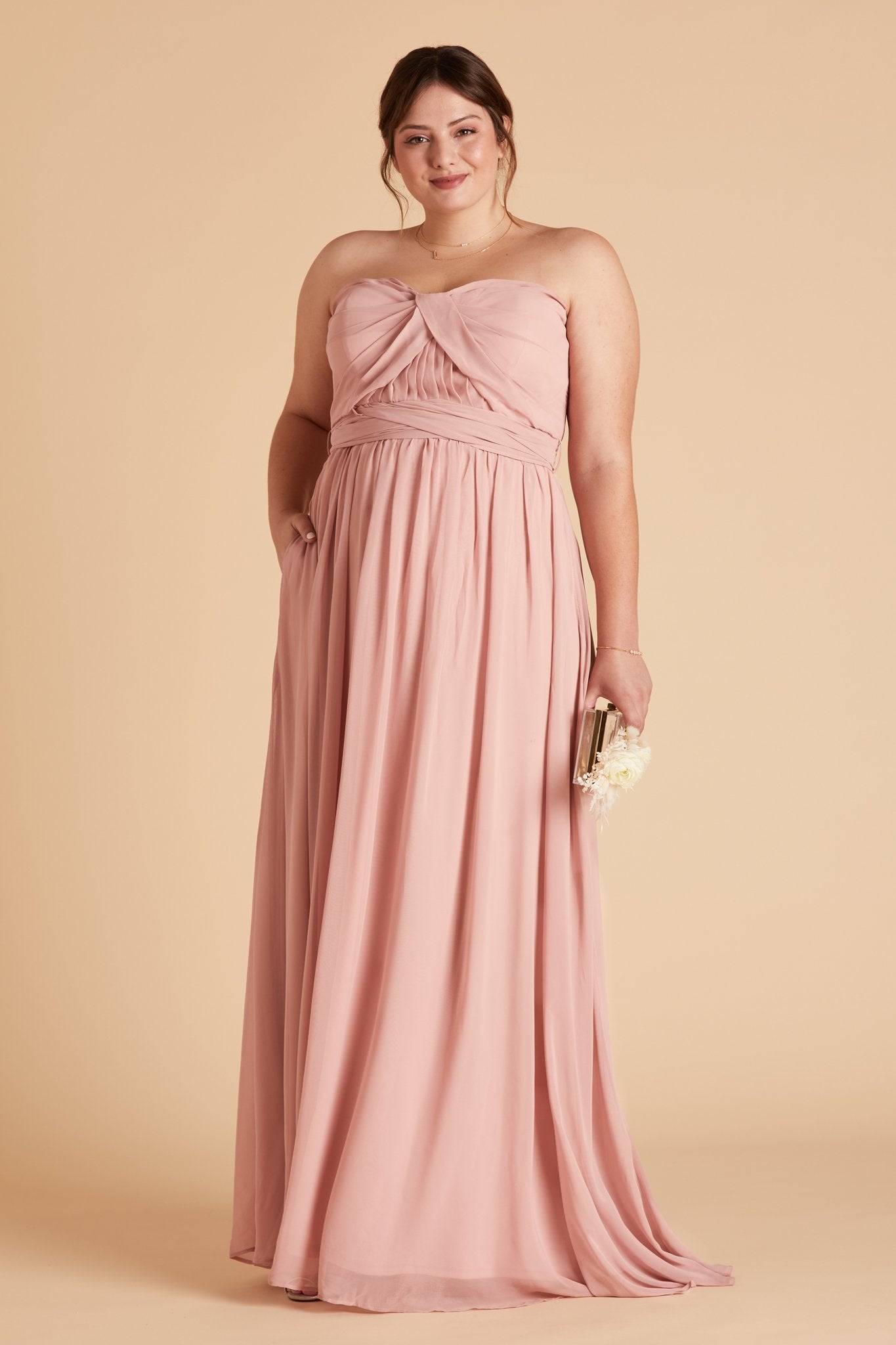 Grace convertible plus size bridesmaid dress in rose quartz pink chiffon by Birdy Grey, front view with hand in pocket