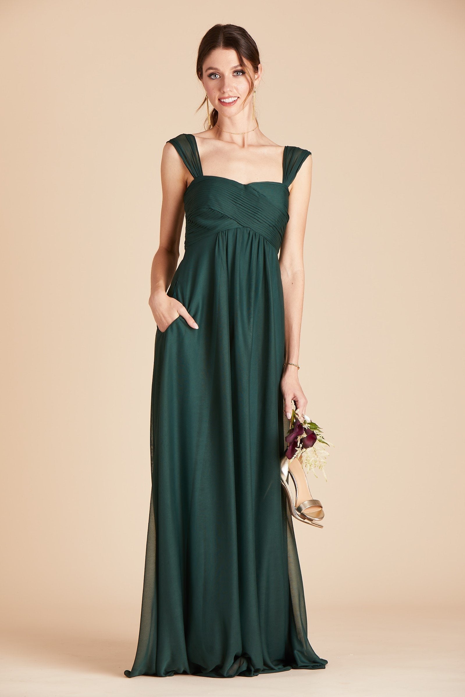 Maria convertible plus size bridesmaids dress in emerald green chiffon by Birdy Grey, front view with hand in pocket