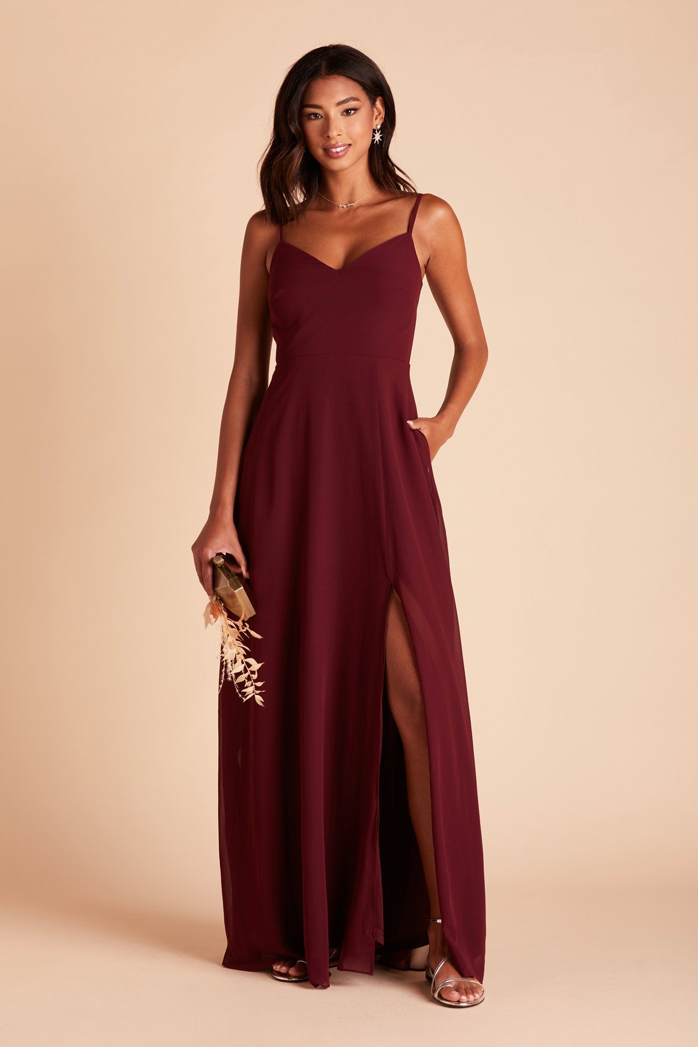 Devin convertible bridesmaid dress with slit in cabernet burgundy chiffon by Birdy Grey, front view with hand in pocket