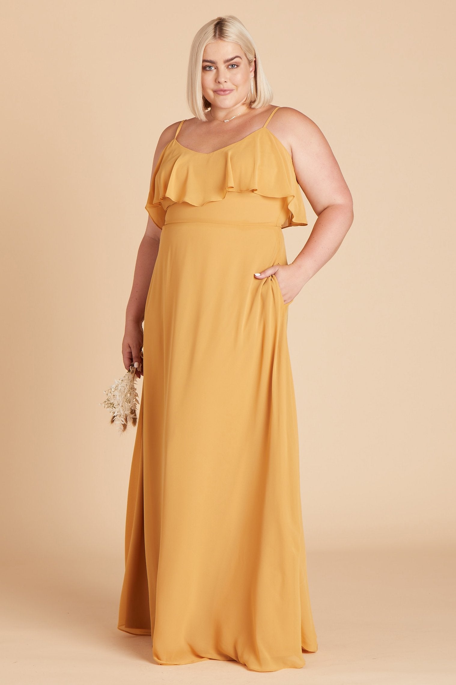 Jane convertible plus size bridesmaid dress in marigold chiffon by Birdy Grey, front view with hand in pocket