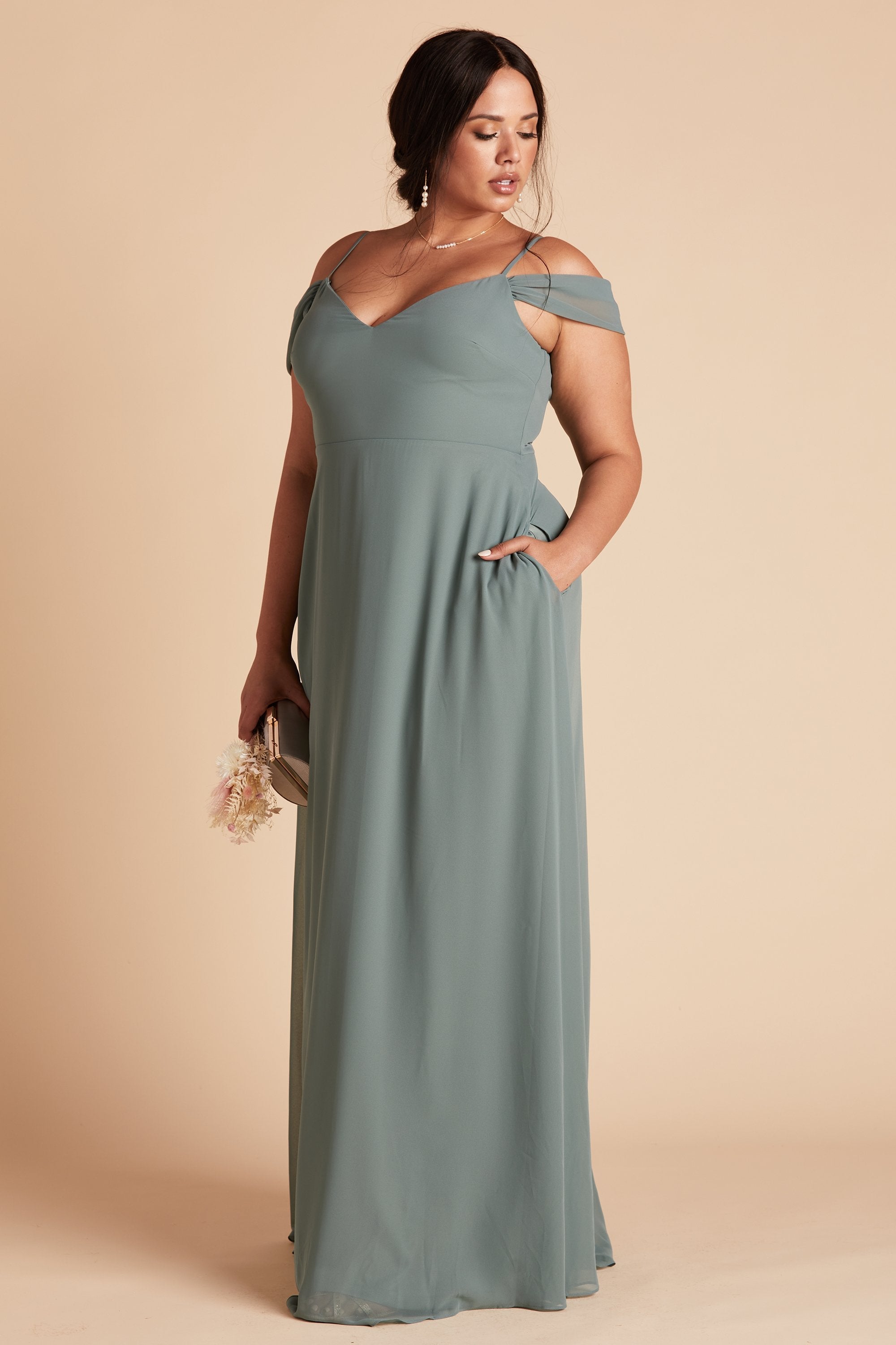 Devin convertible plus size bridesmaids dress in sea glass green chiffon by Birdy Grey, side view with hand in pocket