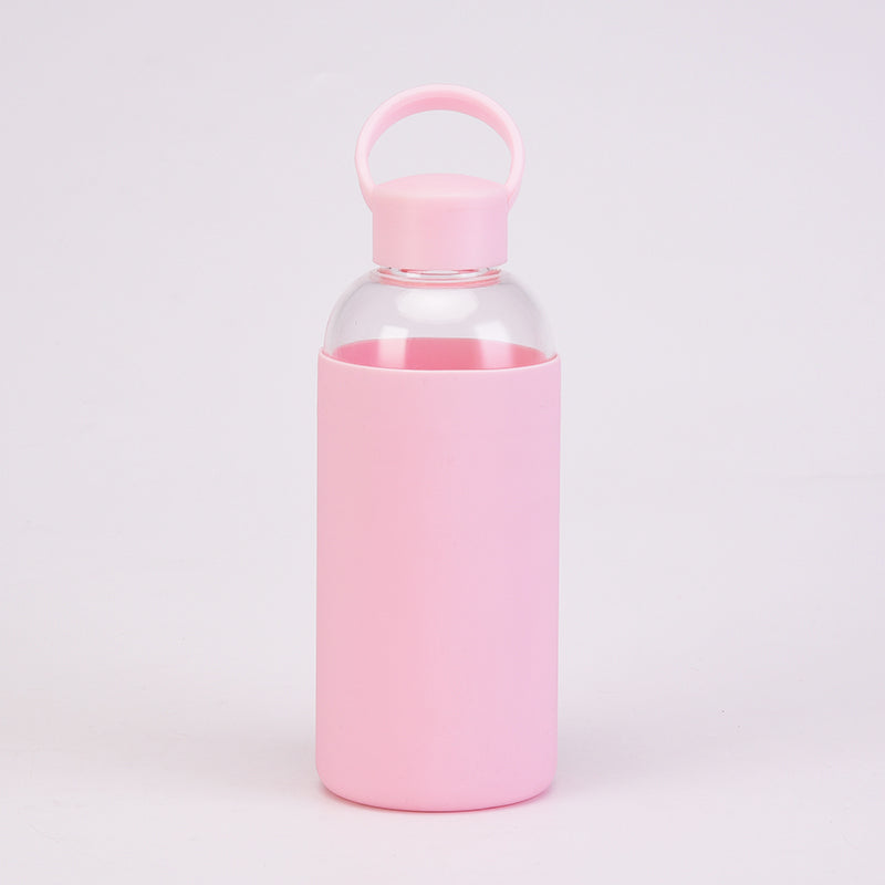 Reusable Glass Water Bottle with a pink cap and pink silicone sleeve drinkware by Birdy Grey, front view