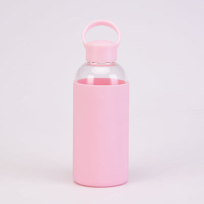 Reusable Glass Water Bottle with a pink cap and pink silicone sleeve drinkware by Birdy Grey, front view