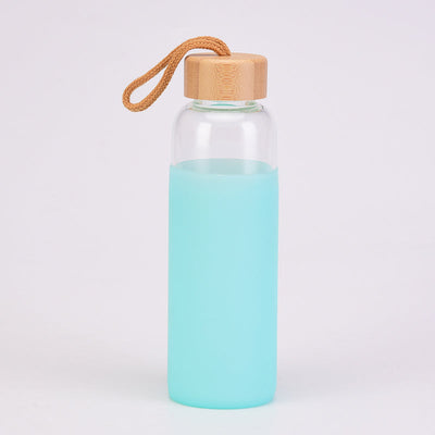 Clear Reusable Glass Water Bottle with Bamboo Cap and silicone sleeve in blue drinkware by Birdy Grey, front view