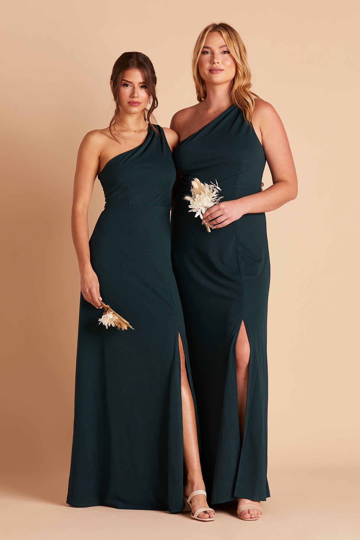 Two women in Kira bridesmaid dress with slit in emerald green crepe by Birdy Grey, front view