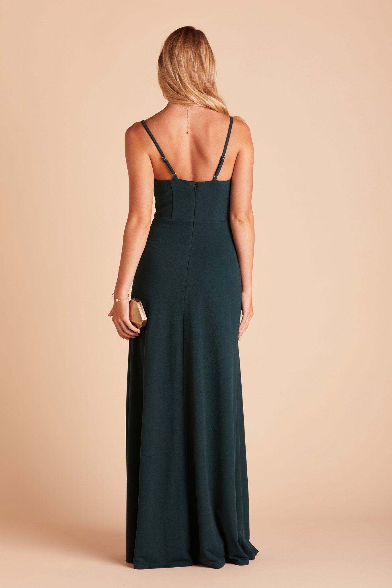 Back view of the Ash Bridesmaid Dress in emerald crepe shows skinny adjustable straps as well as an open back just below shoulder blades.