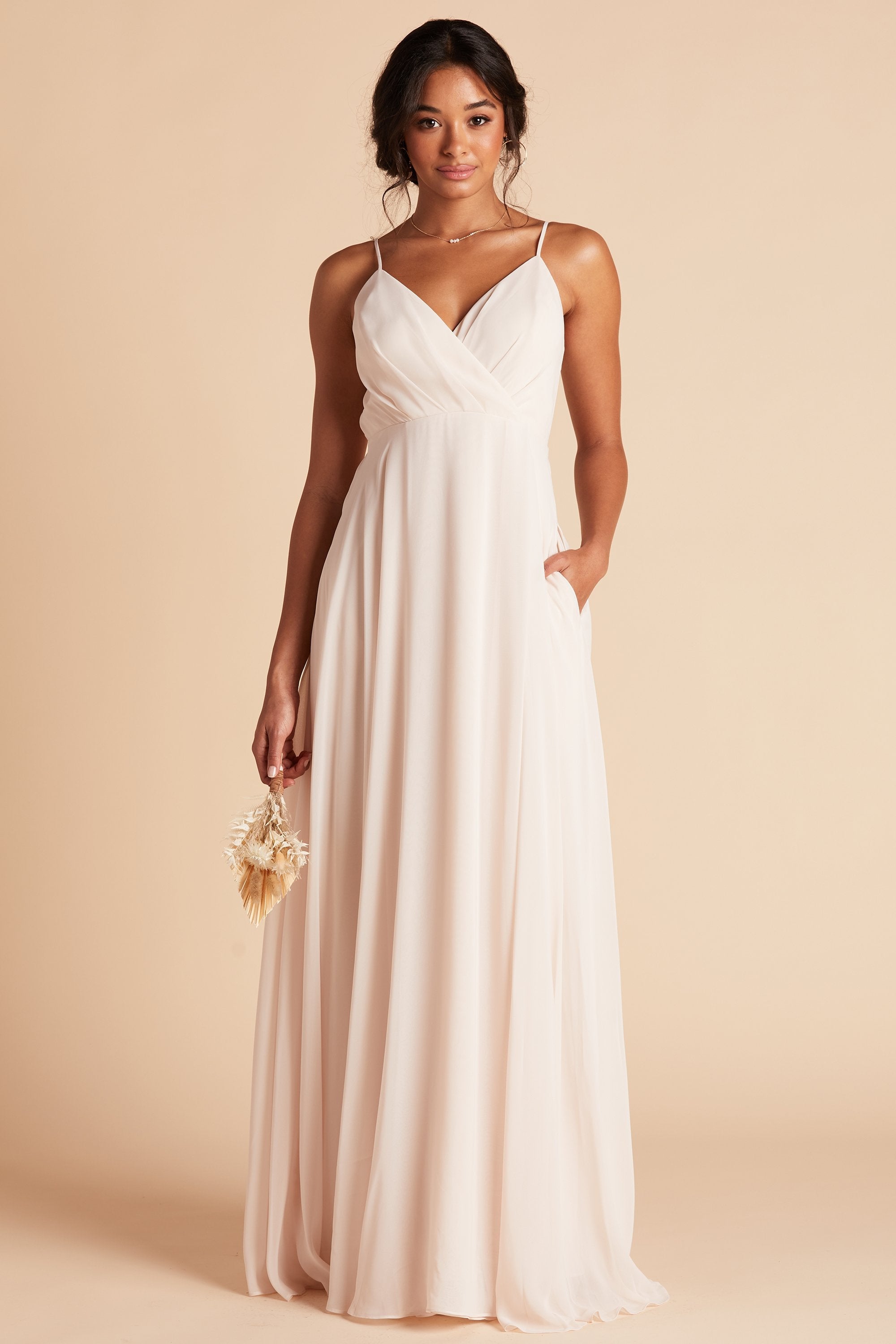 Kaia bridesmaids dress in champagne chiffon by Birdy Grey, front view with hand in pocket