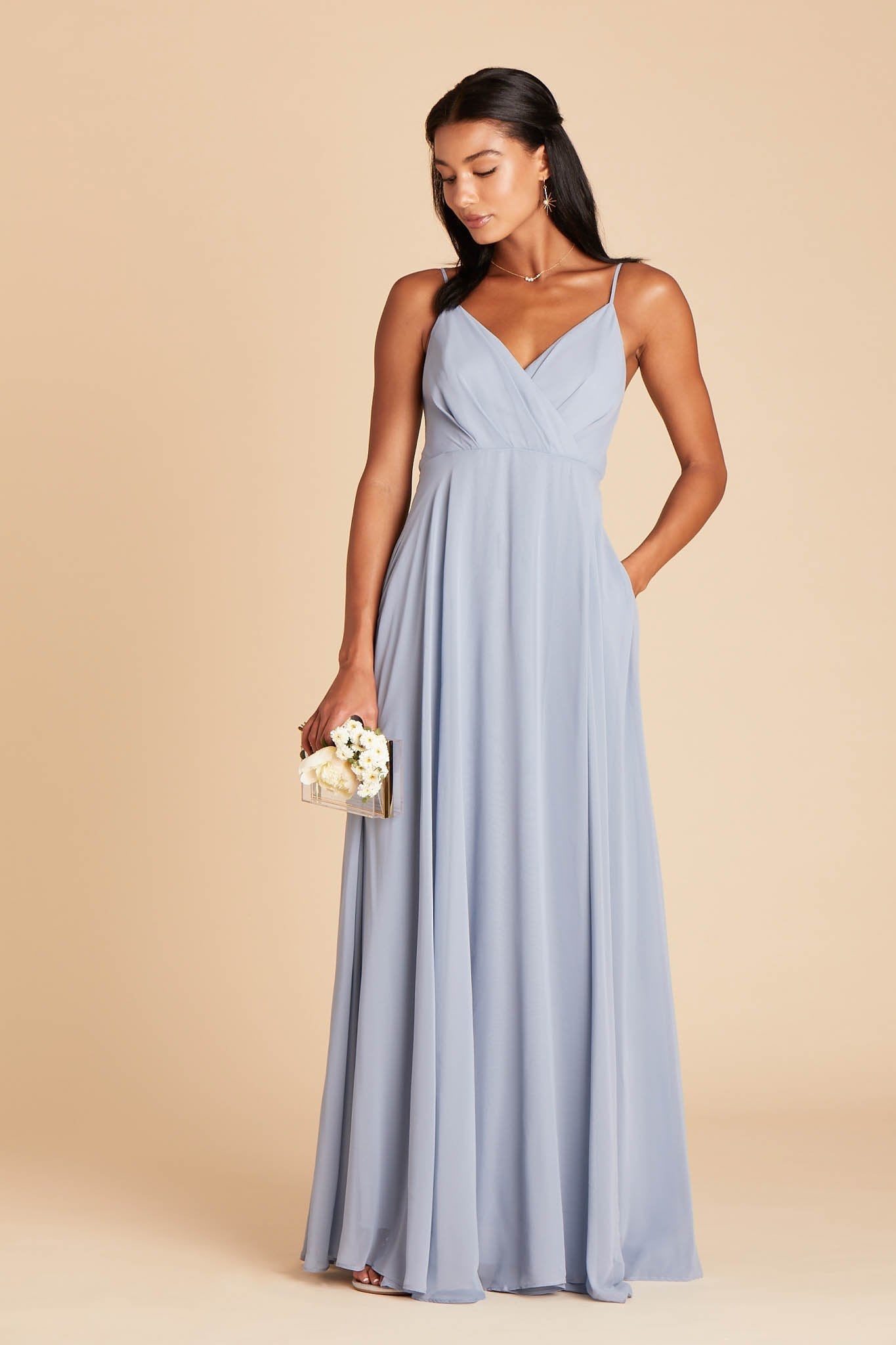 Kaia bridesmaids dress in dusty blue chiffon by Birdy Grey, front view with hand in pocket