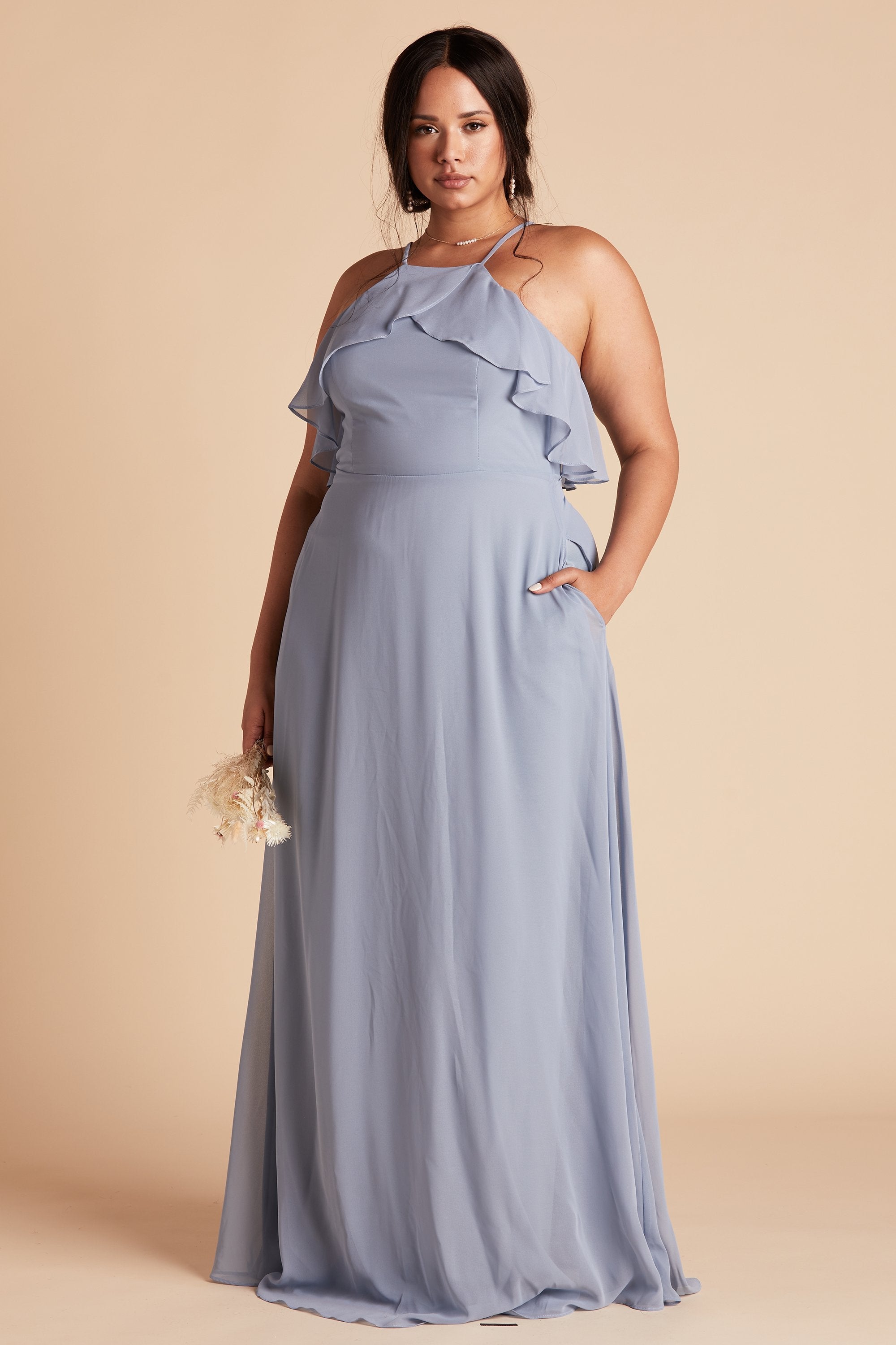 Jules plus size bridesmaid dress in dusty blue chiffon by Birdy Grey, front view with hand in pocket