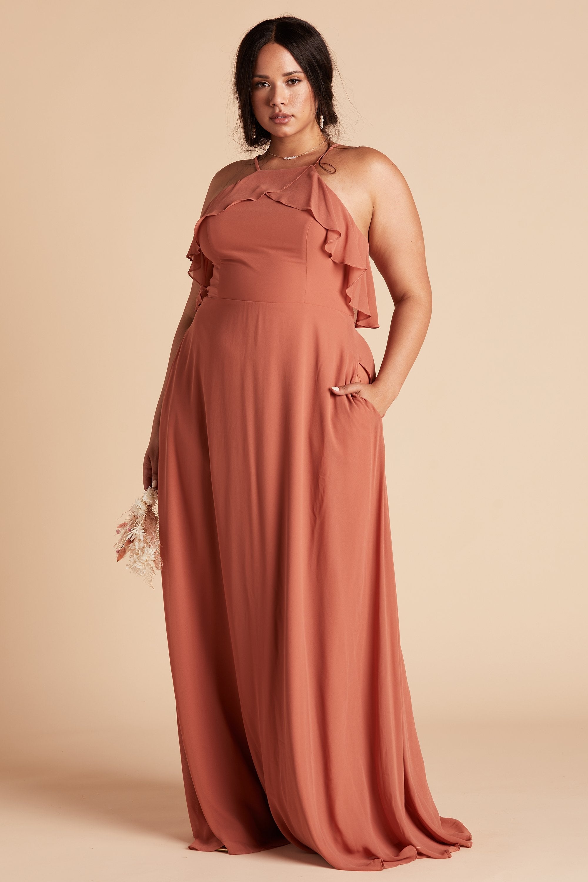 Jules plus size bridesmaid dress in terracotta orange chiffon by Birdy Grey, front view with hand in pocket