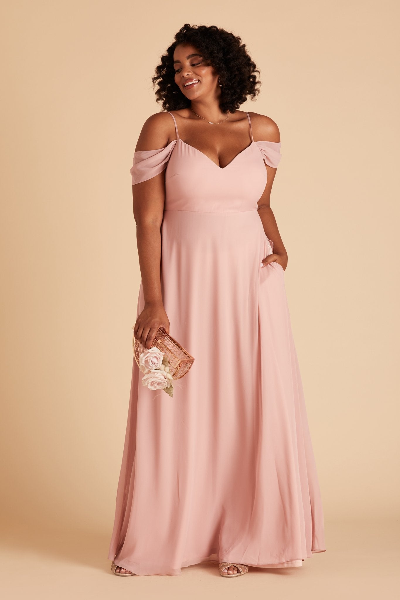 Devin convertible plus size bridesmaids dress in dusty rose chiffon by Birdy Grey, front view with hand in pocket