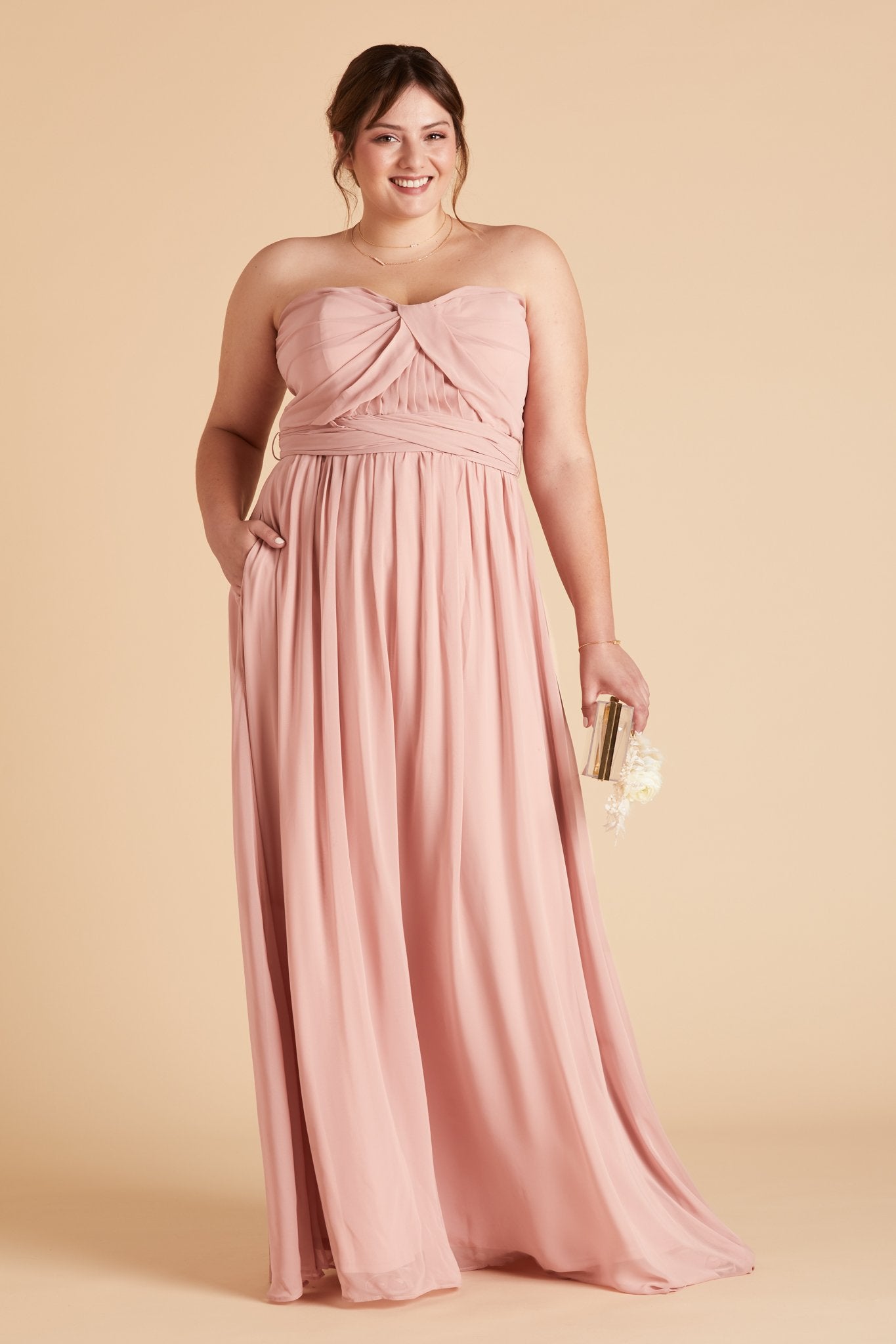 Grace convertible plus size bridesmaid dress in rose quartz pink chiffon by Birdy Grey, front view with hand in pocket