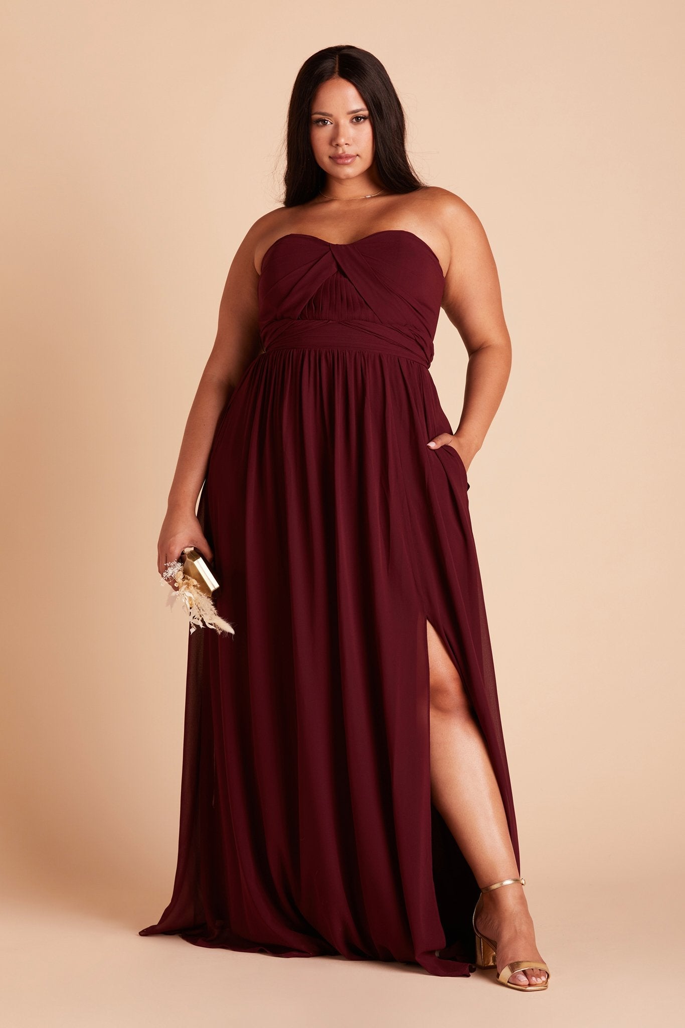 Grace convertible plus size bridesmaid dress with slit in cabernet burgundy chiffon by Birdy Grey, front view with hand in pocket