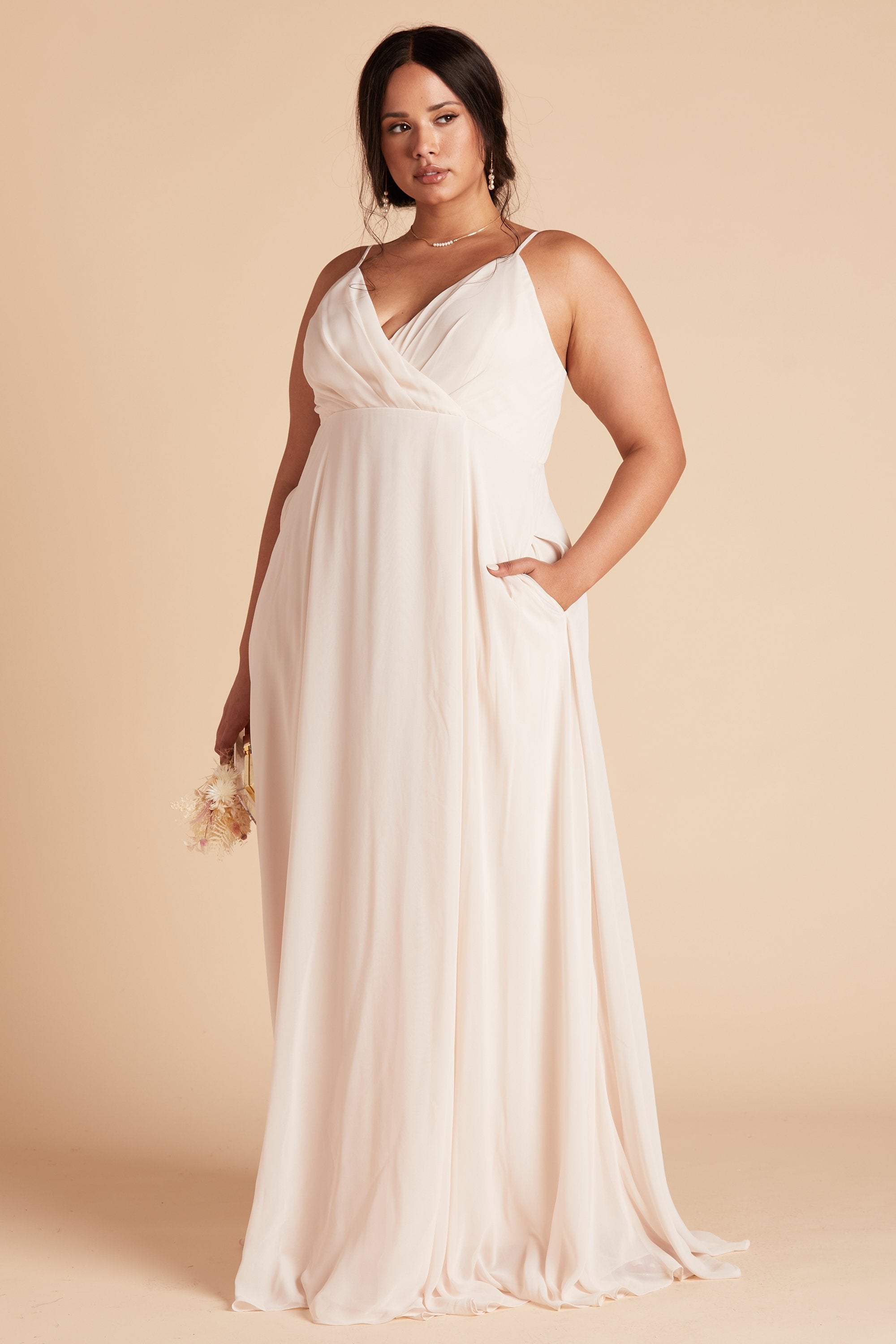 Kaia plus size bridesmaids dress in champagne chiffon by Birdy Grey, front view with hand in pocket