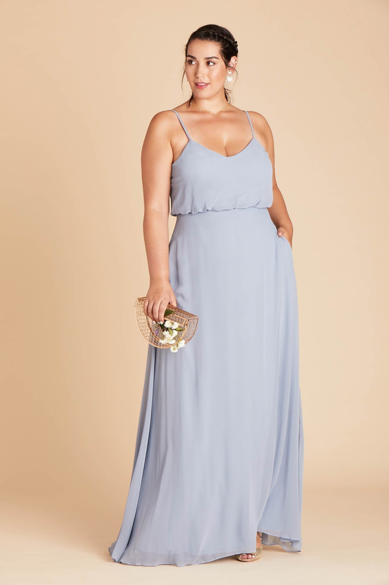 Gwennie plus size bridesmaid dress in dusty blue chiffon by Birdy Grey, front view with hand in pocket