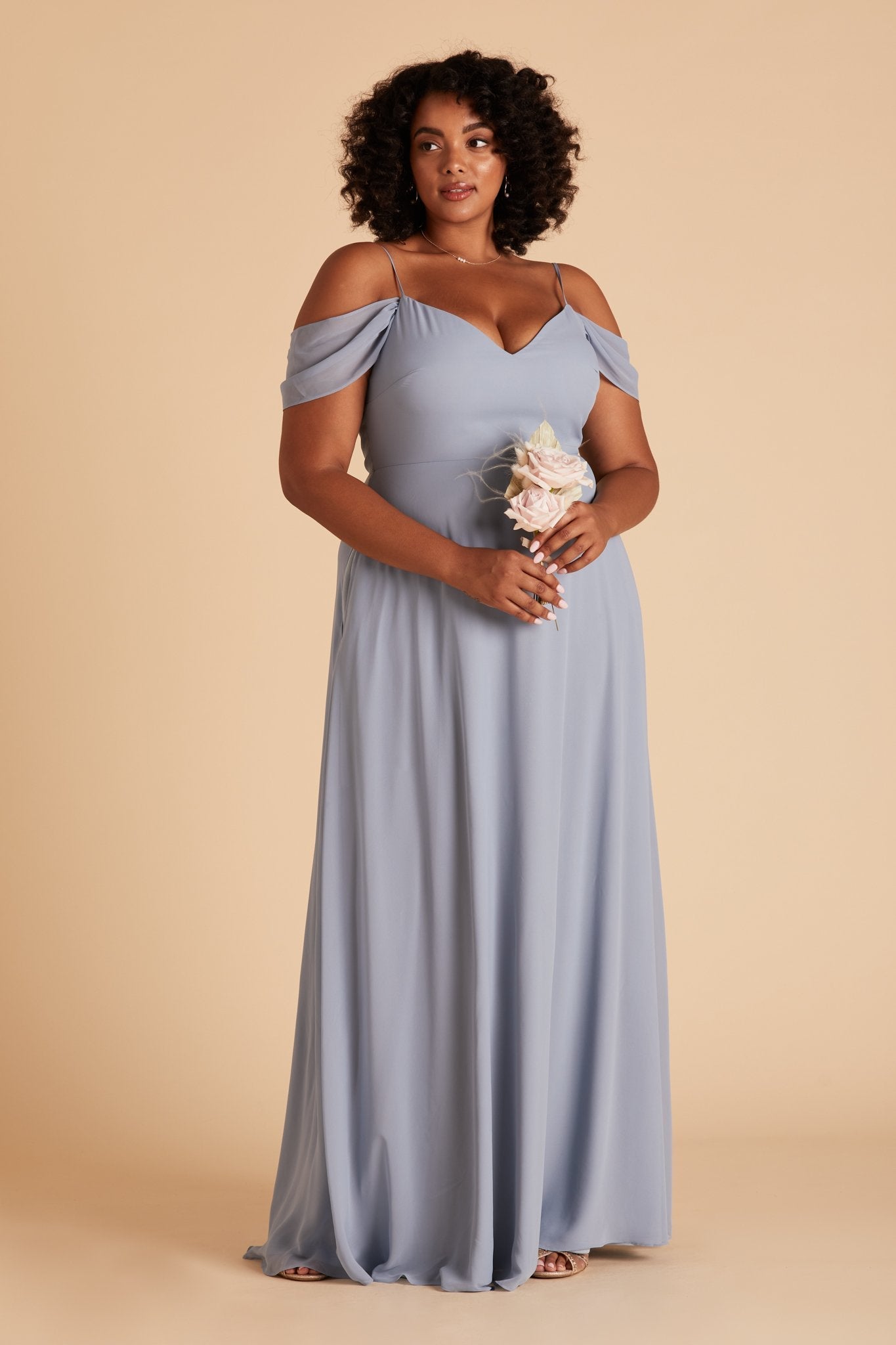 Front view of the floor-length Devin Convertible Plus Size Bridesmaid Dress in dusty blue chiffon with a V-neck front. The flowing skirt has no slit, as this is an optional feature.