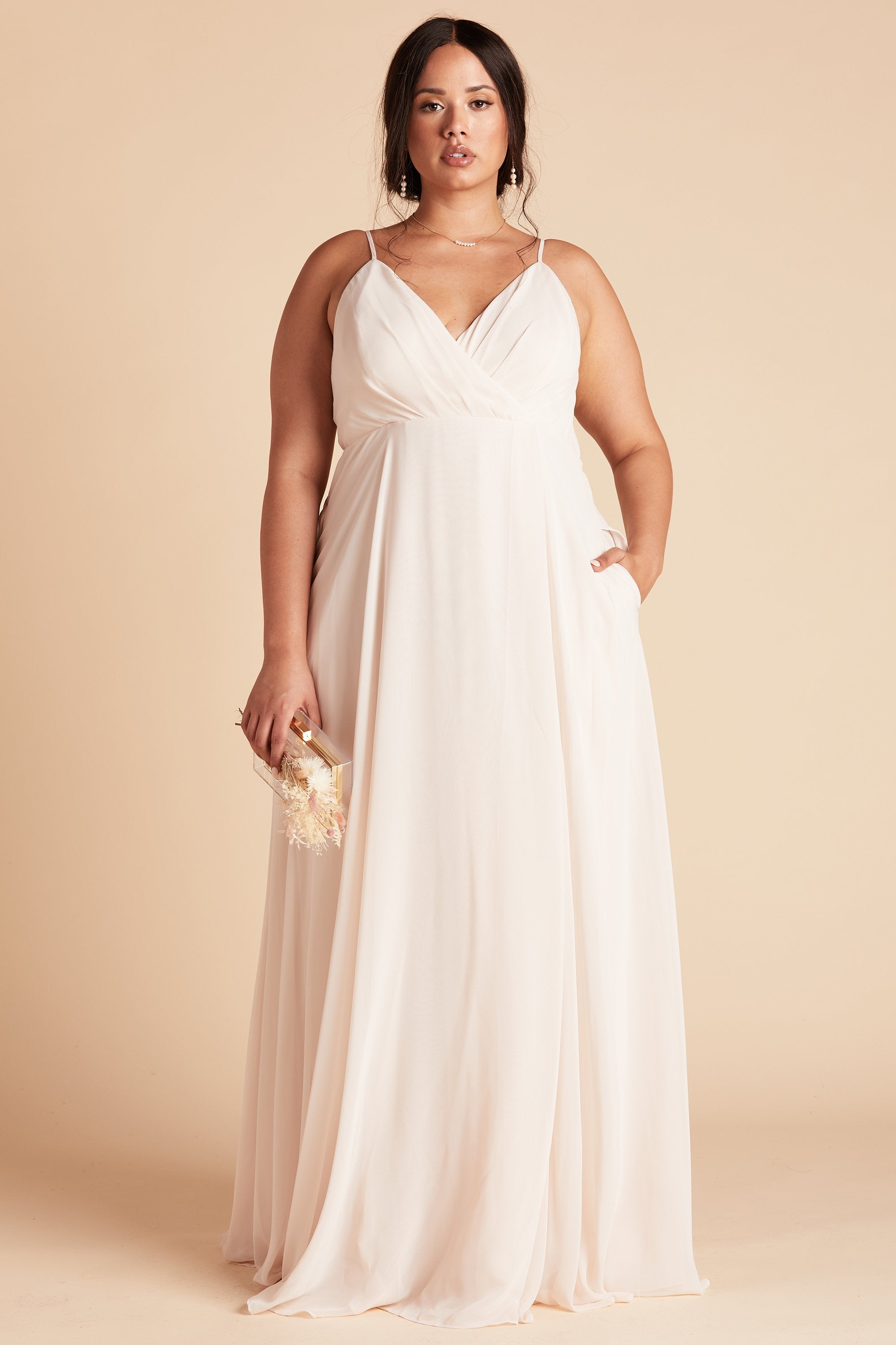 Kaia plus size bridesmaids dress in champagne chiffon by Birdy Grey, front view with hand in pocket