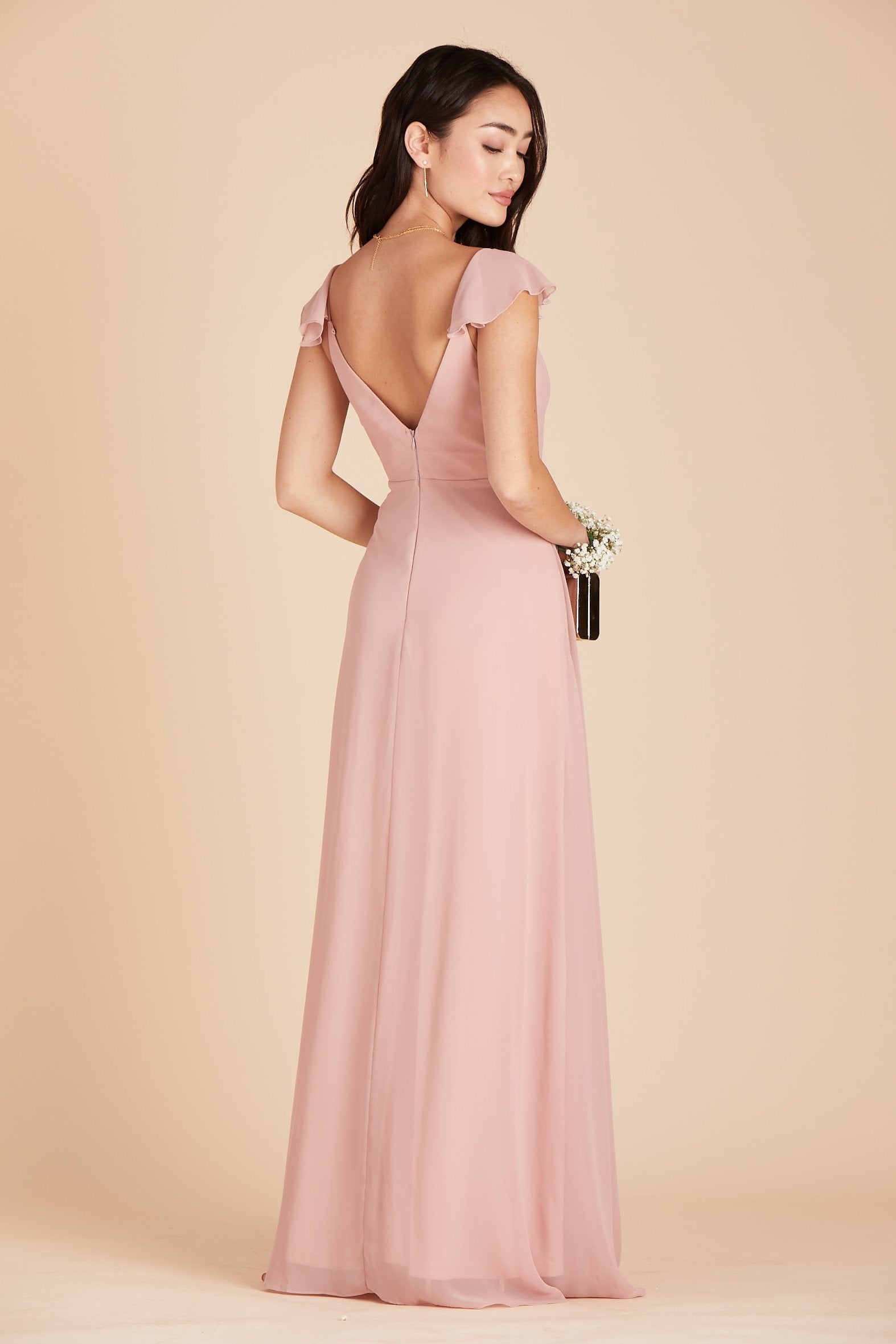 Front view of a floor length dress in dusty rose chiffon worn by a slender model with a light skin tone. 